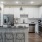 Spacious and well lit kitchen with wood flooring and stainless steel appliances