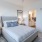Large well lit bedroom with plush carpets and large windows 