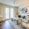 Spacious and well lit living room with wood flooring, large windows and open access to the kitchen