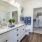 Large well lit bathroom with white accents 