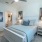 Large well lit bedroom with plush carpets and large windows 